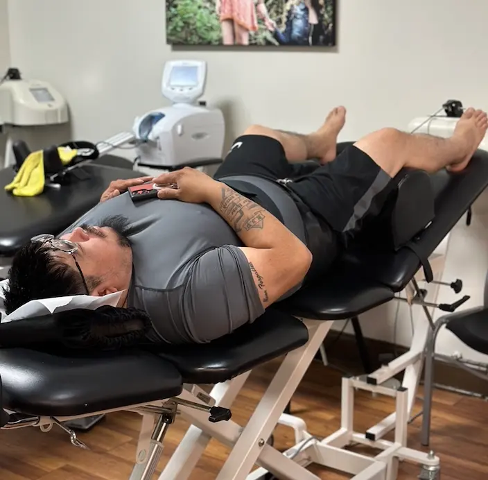 Patient receiving chiropractic care and treatment for musculoskeletal pain.