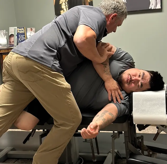Chiropractor performing spinal adjustment on patient in Calhoun GA.