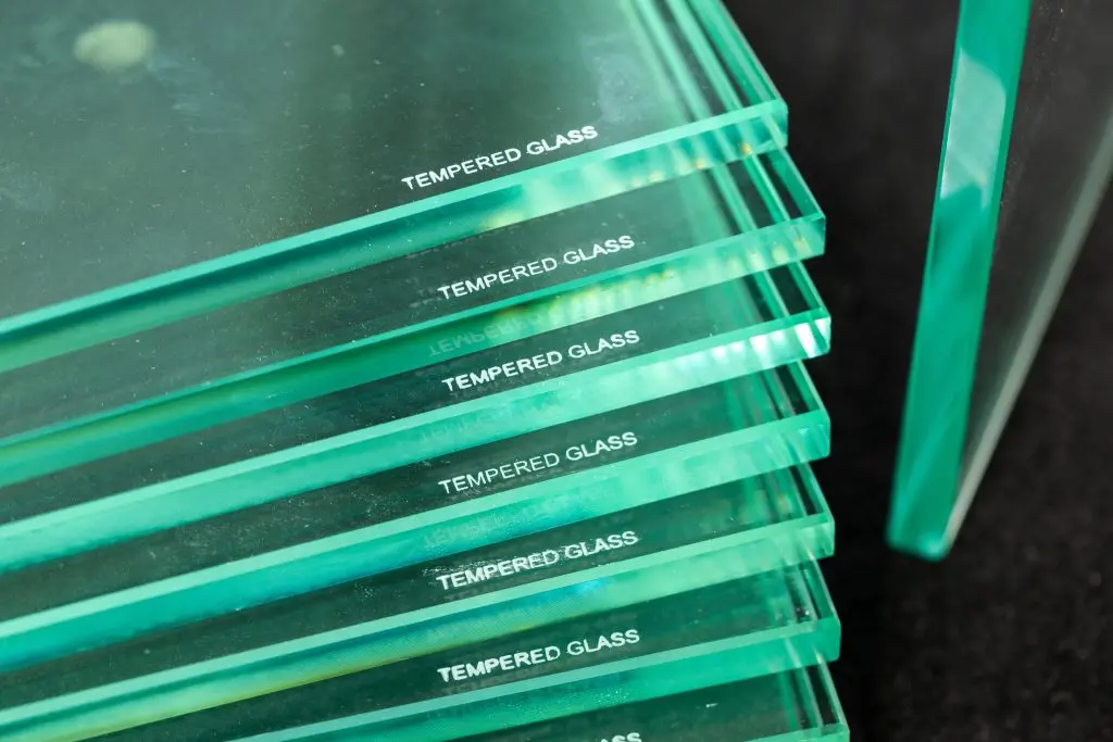 window glass types Toughened glass, protection of glass panes in a special furnace, Burnt inscription denoting ready and protected material against easy breakage. Glass industry