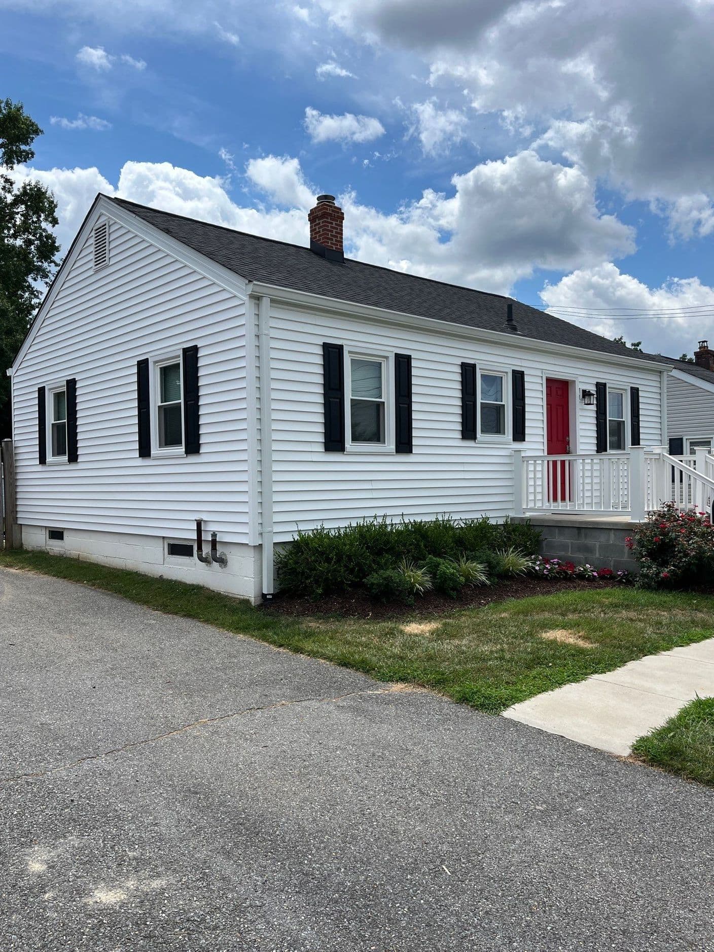 New siding on a white cottage-style home in Frederick, Maryland
