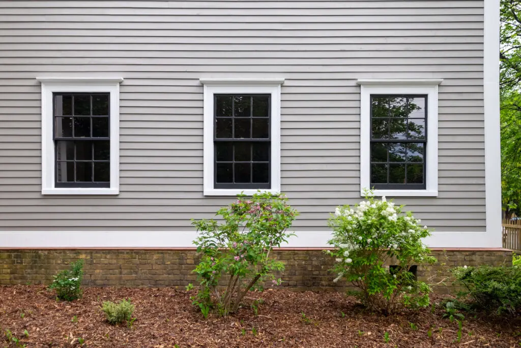 how long do windows last-exterior view of 3 house windows on a light gray home