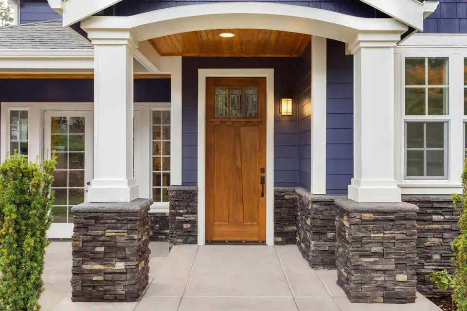 how to pick a front door color-navy blue house with a walnut stained wood front door