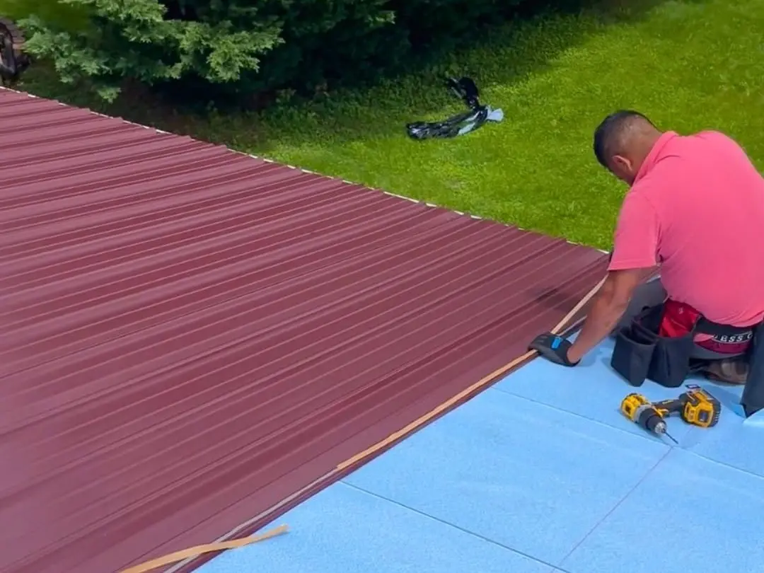 workers installing metallic roof