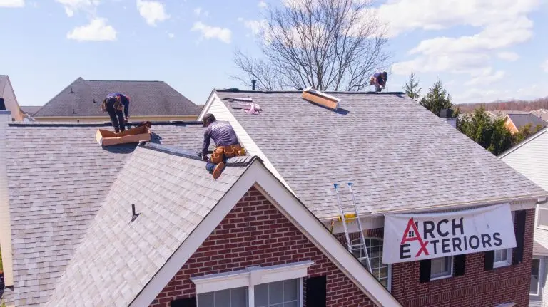 james hardie siding warranty workers installing grey shingles roof
