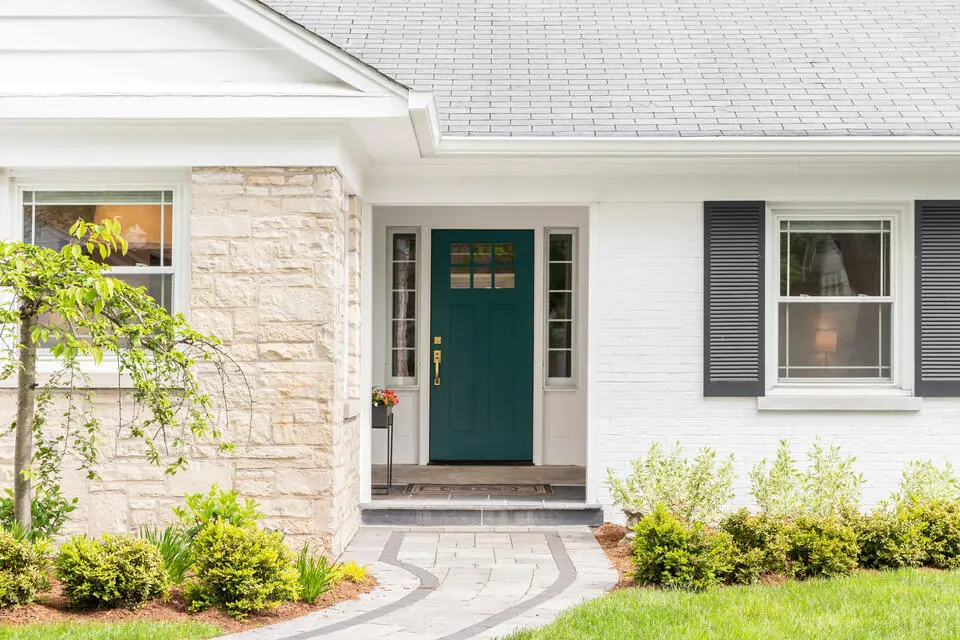 how to pick a front door color-white brick house with a dark green front door