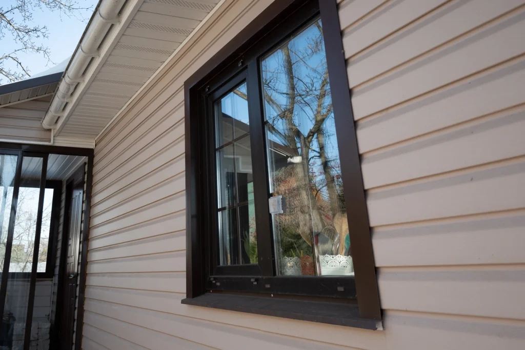 close up of black vinyl windows installed on beige home in maryland