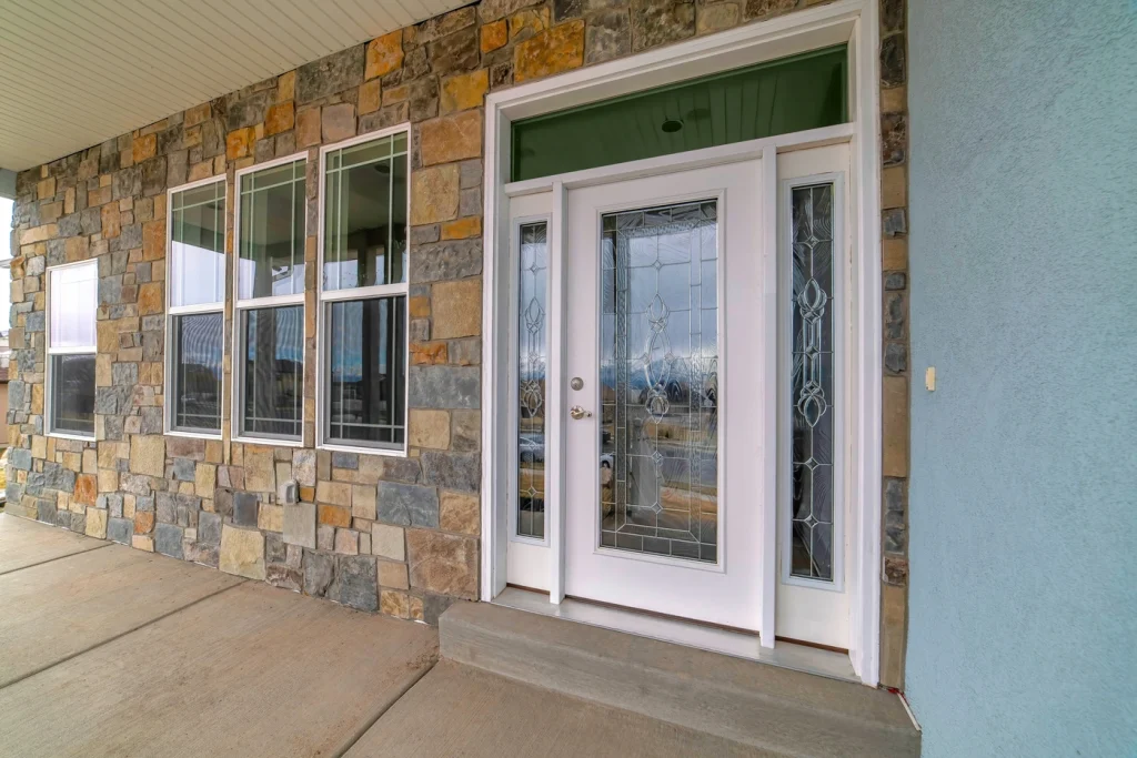 close up of home entryway with transom windows above door