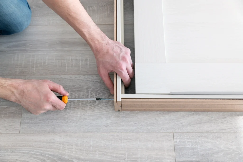 man working on fitting frame for exterior door installation