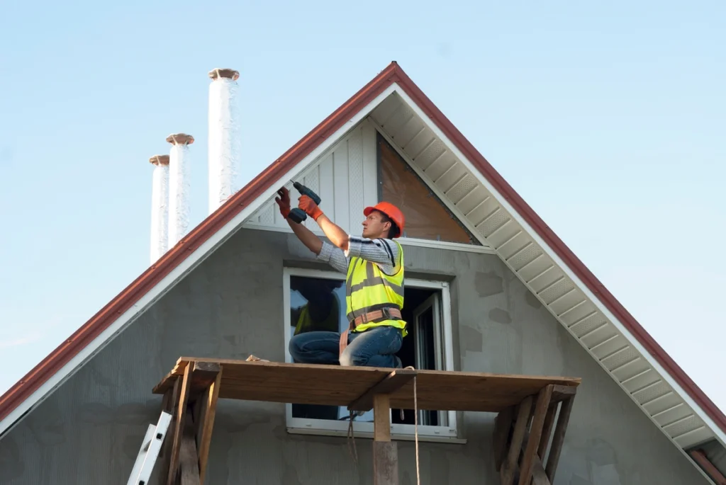 man installing a white frieze board
