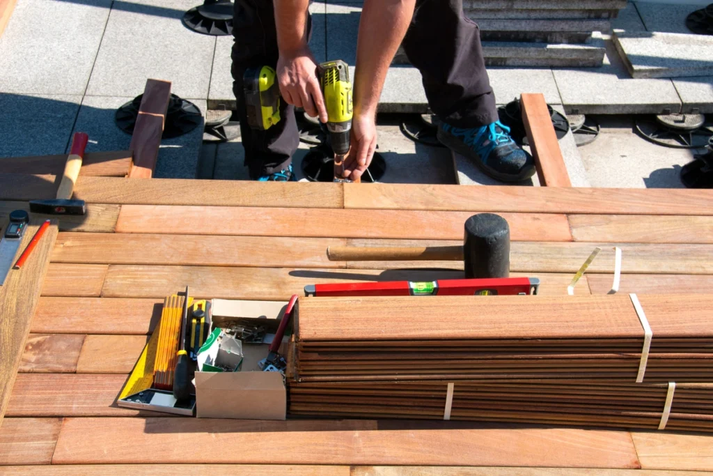 man with power drill showing how to install composite decking 