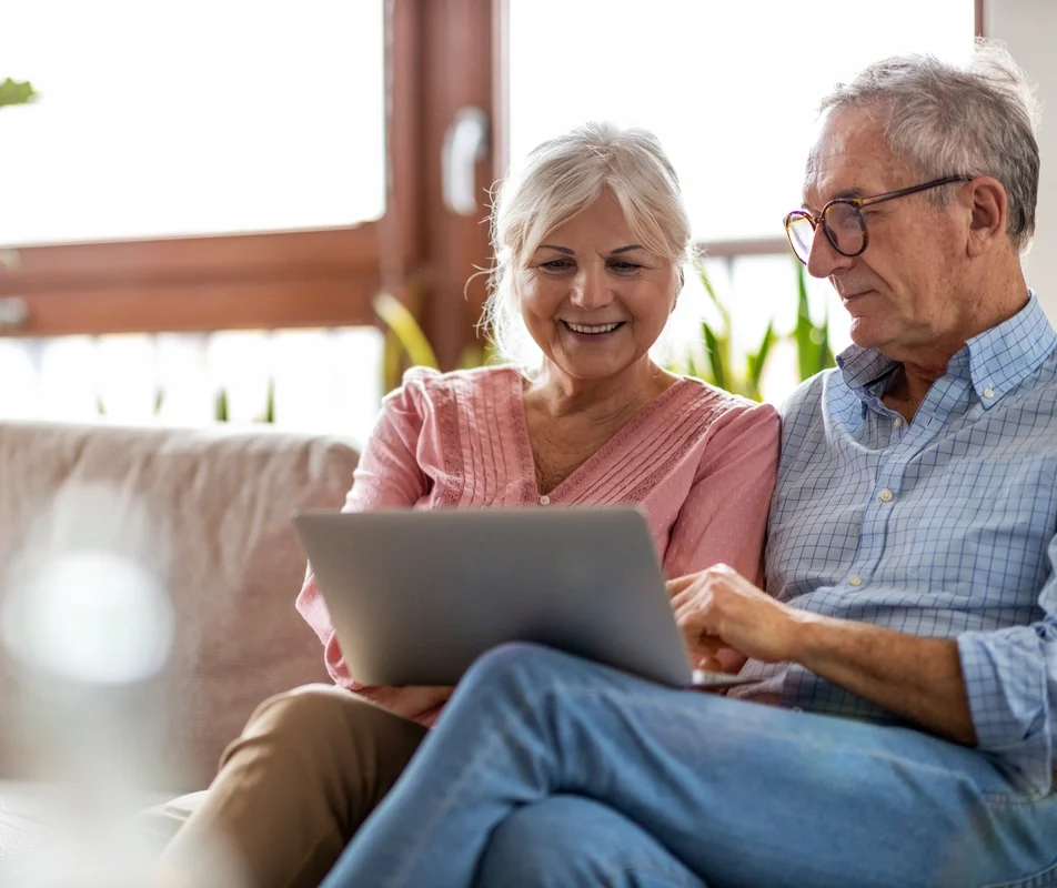 elder couple using laptop