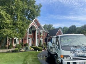 Exterior cleaning and window cleaning a house in Orchard Park, NY