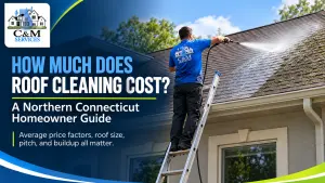 Roof cleaning professional washing a residential roof for a Northern Connecticut home with C&M Services branding