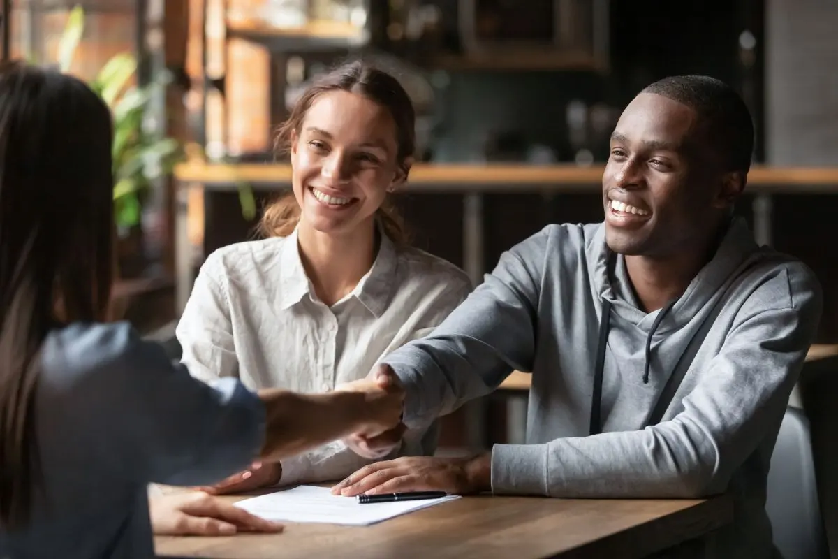 financing young couple closing deal with bank worker inside office