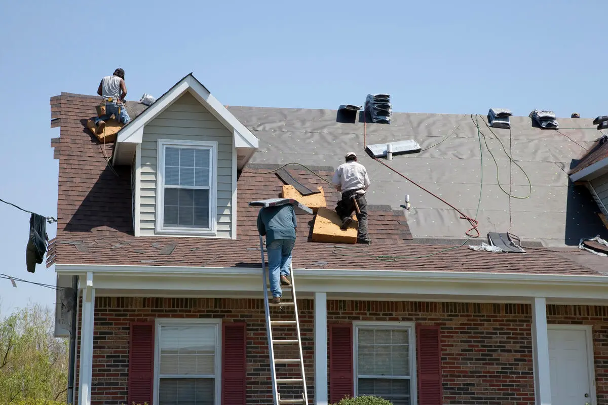 team installing new shingles