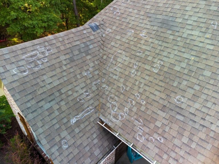 Roof hail damage holes after storm inspection