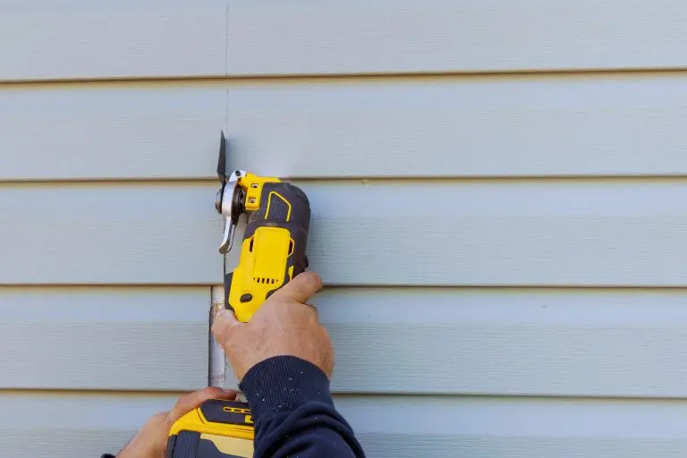 siding moline Reconstruction of house involves removal damaged vinyl siding with multi tool