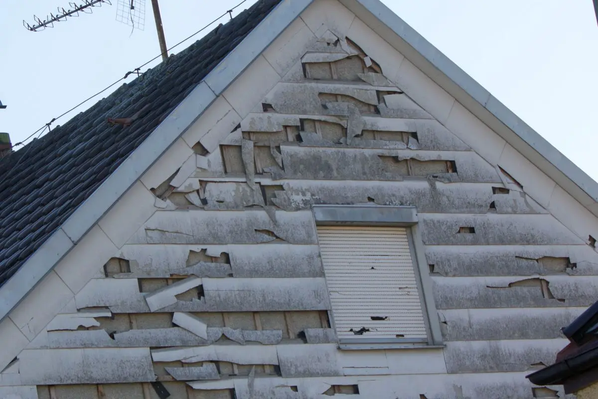 warped siding white storm and hail damage