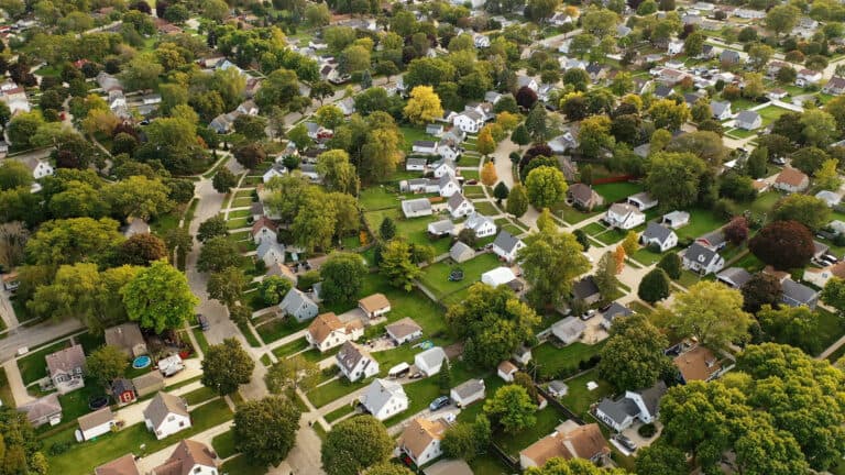 Aerial drone view of American suburban neighborhood at daytime.