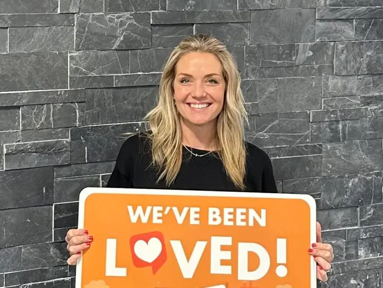 woman holding orange sign