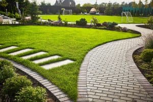 - Search Strategy Marketing - Search Strategy Marketing Landscaping of the garden path curving through Lawn with green grass and walkway tiles