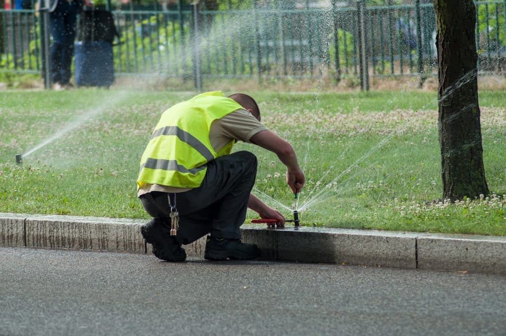 | Search Strategy Marketing | Search Strategy Marketing an irrigation expert adjusting automatic sprinklers on tramway line