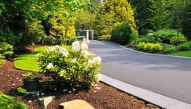a beautiful driveway and landscaped entrance by a landscape contractor