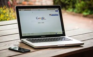 A laptop showing Google’s home page.