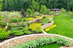 Natural landscaping with low retaining walls and plants in home garden