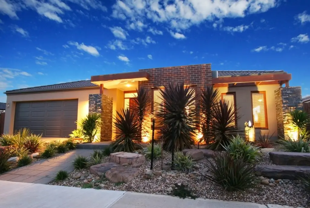 contemporary home with beautiful landscape lighting
