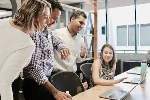 Alt-tag: contractor team in a meeting room discussing working with a marketing agency