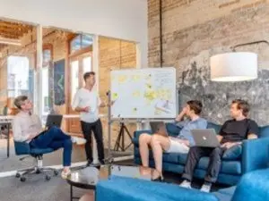 Marketing team in a meeting room discussing working with a HubSpot partner agency