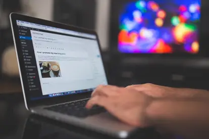 image-2 | Search Strategy Marketing A person typing a blog post on a laptop. Article discusses marketing plugins for wordpress.