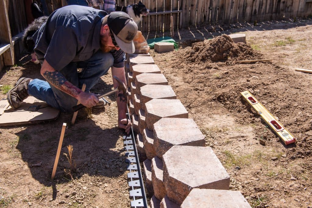 a landscaper constructing a home yard wall
