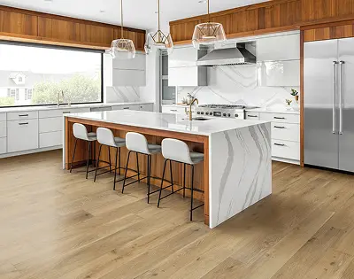 Modern kitchen featuring Zanzibar hardwood flooring from The Palms Collection, showcasing wide-plank European oak, sleek cabinetry, and stylish bar stools.