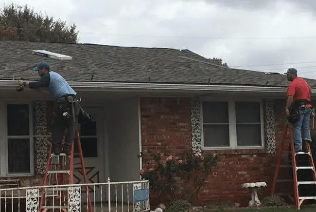 roofers inspecting a roof