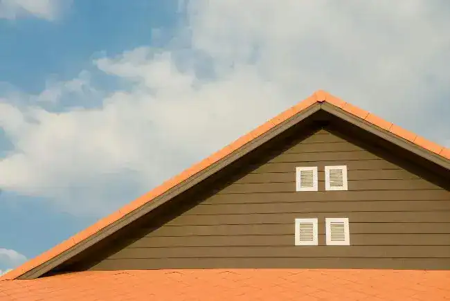 A roof and a cloudy sky.