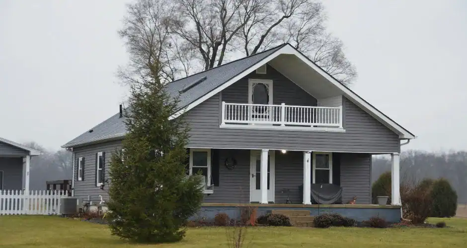 Gray home with complementary roof and white exterior trim