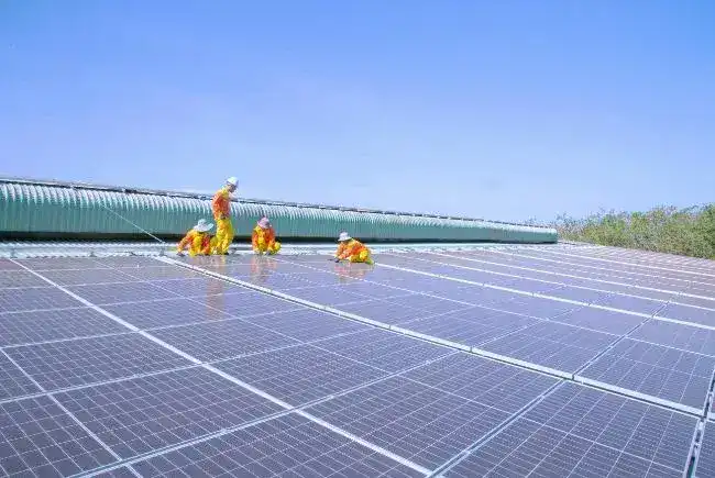 Professionals installing solar panels on the roof.