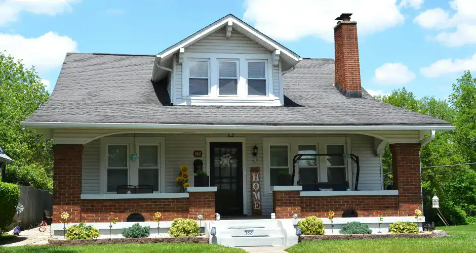 White home with dark gray roof shingles and contrasting exterior trim