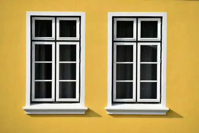 windows against a yellow wall.