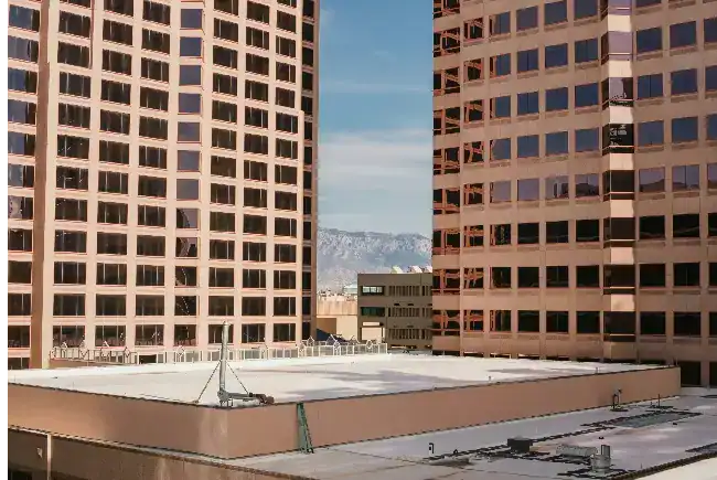 building with a flat roof system surrounded by other commercial properties