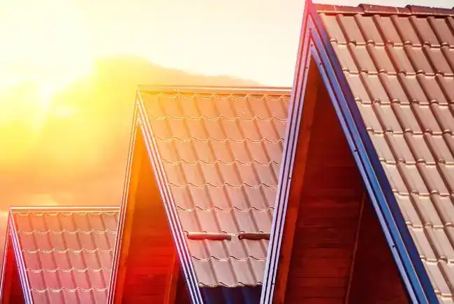 sun rising over metal roofs