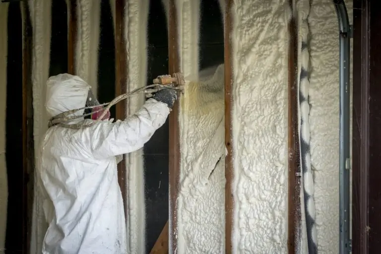 Worker spraying closed cell spray foam insulation