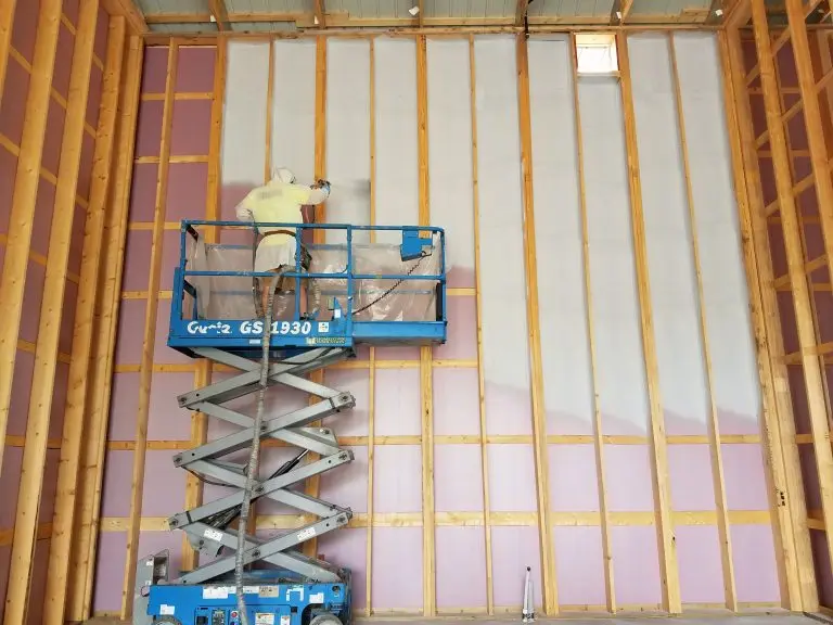 Hometown Insulation working on insulation installation on a large wall