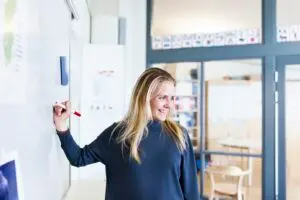 teacher writing on whiteboard