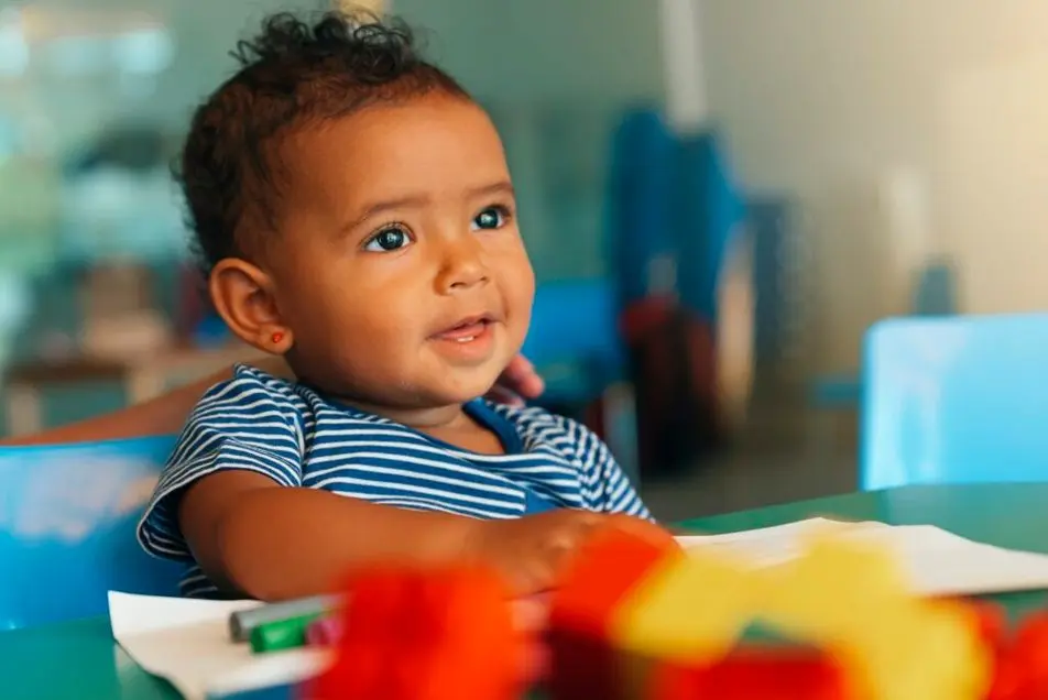 happy baby playing with toy blocks