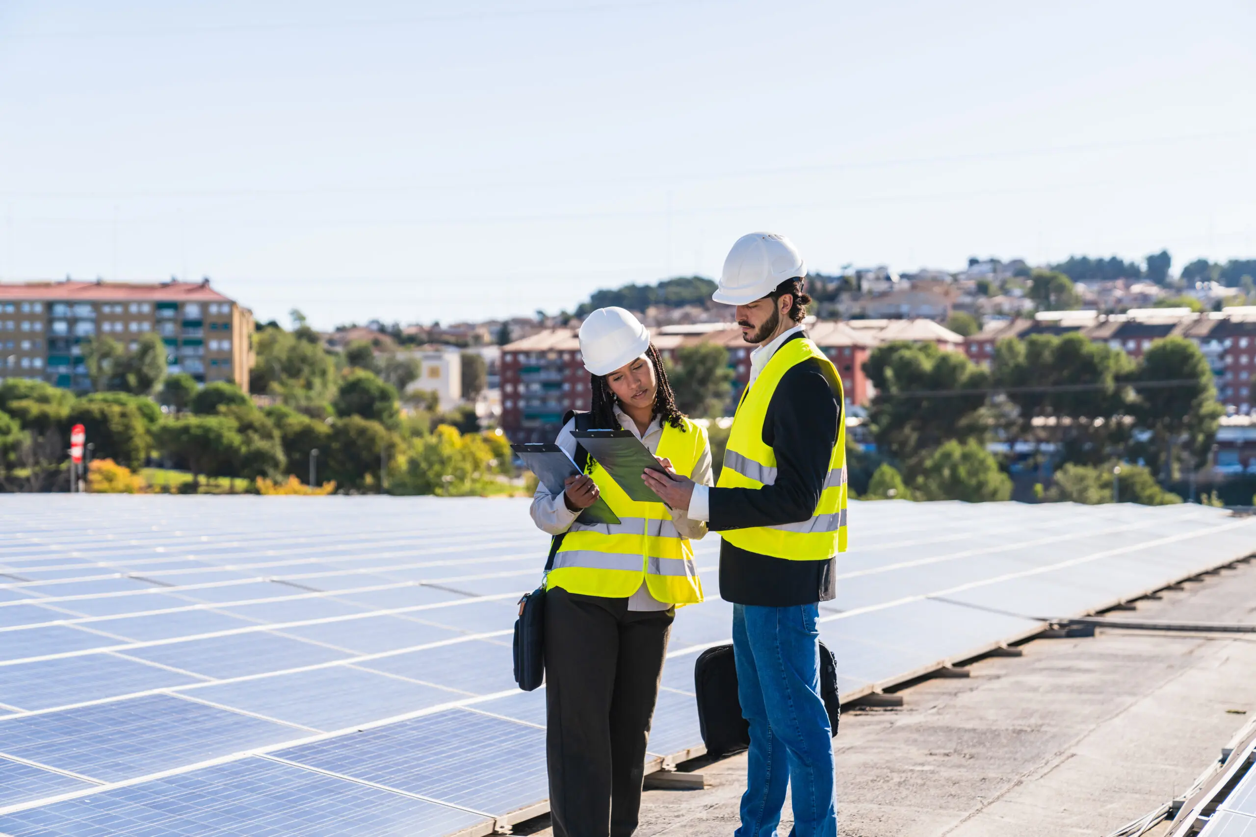Engineers inspecting solar panels for sustainable energy generation