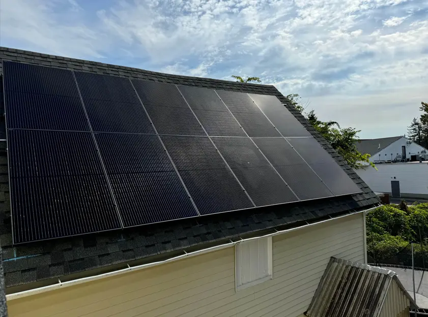 small yellow house black solar panels