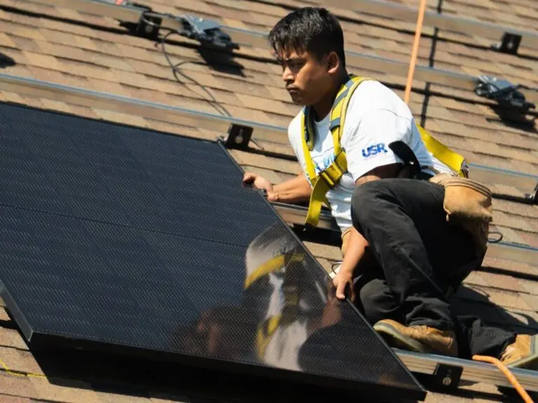 Suncovia worker installing solar panel